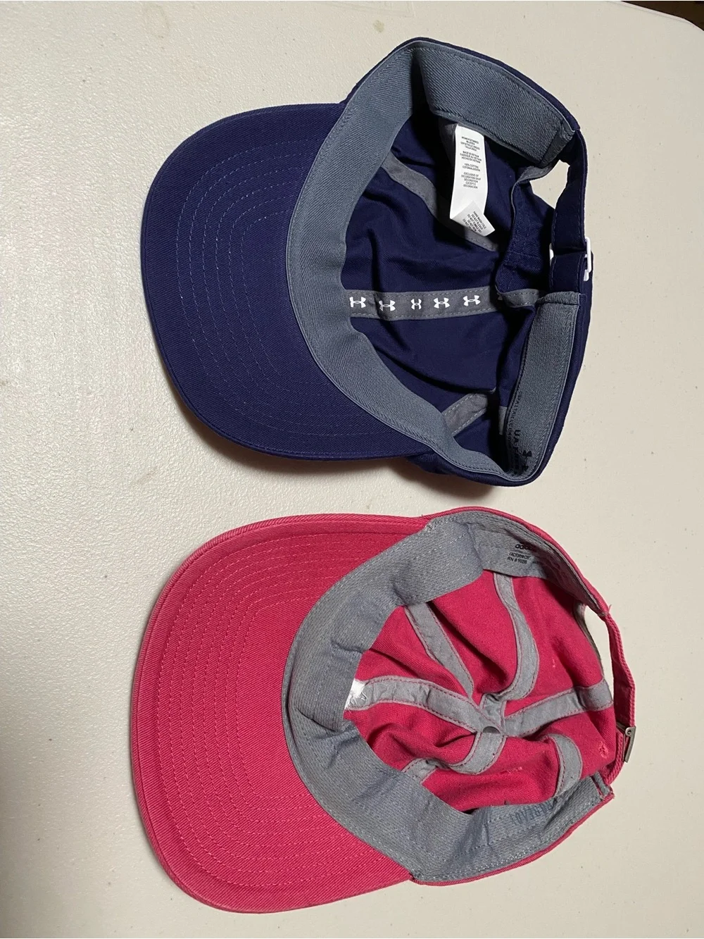 NWOT 2 for 19 NWOT Adidas pink & Under Armour navy logo baseball caps - set of 2